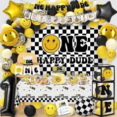 a table topped with lots of yellow and black balloons next to a checkered wall