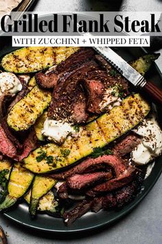 grilled flank steak with zucchini and whipped feta on a black plate