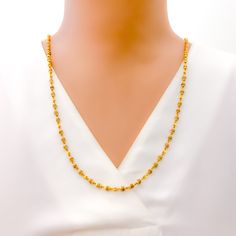 This luxurious necklace is skillfully crafted with 22k gold, totaling 11.8 grams, with 11.0 grams in gold and 0.8 grams in Tulsi beads. It showcases a radiant yellow gold finish and measures 26 inches in length, seamlessly designed without a lock for uninterrupted elegance. The subtle inclusion of Tulsi beads adds a touch of spiritual significance, making this piece not only a fashion statement but also a nod to cultural heritage. Ideal for those seeking jewelry that blends sophistication with m 22k Gold Jewelry With Delicate Chain, Gold Plated Temple Necklace With Tilla, Gold Plated Yellow Gold Temple Necklace With Tilla, Yellow Gold Temple Necklace With Tilla, Gold Plated, Gold Necklaces With Tilla Detailing In 22k Gold, 22k Gold Necklaces With Tilla Detailing, Yellow Gold Temple Necklace With Tilla Detailing, 22k Gold Necklace With Tilla, Gold Necklaces With Tilla Detailing