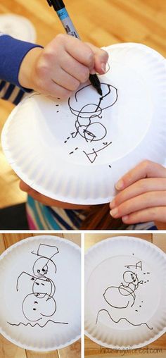 a person is drawing on a paper plate