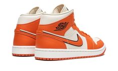 The Women’s Air Jordan 1 Mid “Sport Spice” is a women’s-exclusive colorway of the casual shoe with a premium and eye-catching construction.  The “Sport Spice” is complete with a Coconut Milk leather base with Sport Spice (orange) leather overlays featuring a pebbled basketball-like texture.  An orange leather Swoosh with black trim appears on the sides and “Wings” branding is found on the collar.  Classic Jumpman detailing dots the tongue. Womens Air Jordan 1, Womens Air Jordan, Air Jordan 1 Mid Se, Nike Air Jordan 1 Mid, Womens Air Jordans, Stadium Goods, Casual Shoe, Nike Air Jordan 1, Air Jordan 1 Mid