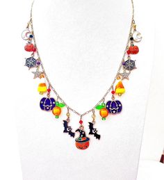 This happy and colorful Halloween charm necklace is handcrafted by myself and a one of a kind original.  The gold plated chain is 20 inches long with 17 drops containing  pumpkins, jack o lanterns, candy corn,  moons, stars, bats and lots of crystals so it sparkles as you move.  It contains an assortment of enamel charms, glass, acrylic and crystals.  If you need it shorter or longer just let me know, and I will adjust it to as close as possible to the size you desire. If you would like a charm Whimsical Handmade Multicolor Charm Necklaces, Handmade Multicolor Charm Necklaces For Parties, Handmade Orange Charm Necklace As A Gift, Handmade Orange Charm Necklace For Gift, Handmade Bohemian Jewelry For Halloween, Halloween Dangle Necklaces As Gifts, Halloween Dangle Necklace For Gift, Customized Multicolor Themed Jewelry, Halloween Gift Dangle Necklace