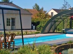 an empty swimming pool in the middle of a yard