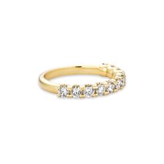 a yellow gold ring with five diamonds