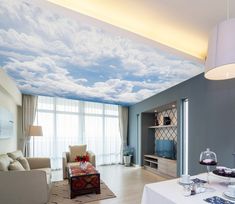 a living room with blue sky and clouds painted on the ceiling