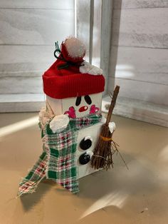 a snowman with a red hat and scarf