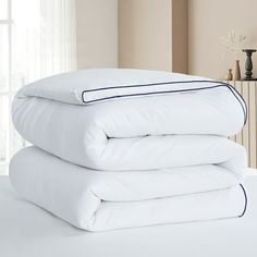 three white pillows stacked on top of each other