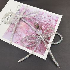 a close up of a brooch on a table with beads and other items in the background