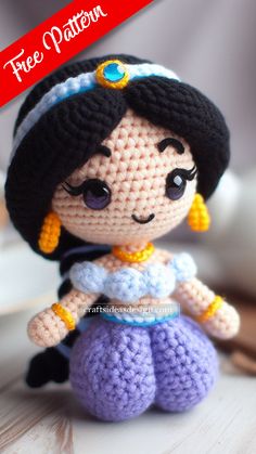 a crocheted doll sitting on top of a wooden table