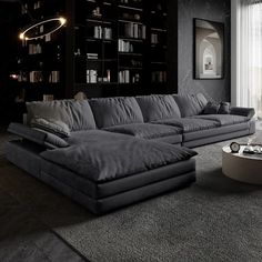 a living room filled with furniture next to a large book shelf covered in lots of books