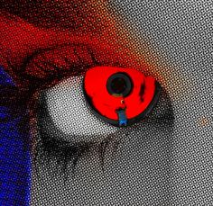 a close up of a person's eye with red and blue colors