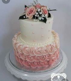 a white and pink cake with flowers on top