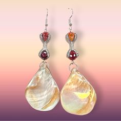 Handmade Silver Tone Metal Unique Tentacle Wrapped Genuine Red & Orange Colored Agate Rounded Gemstones Teardrop Shaped Abalone White Iridescent Shell Drops Easy To Wear 3.5” Long X 3cm Wide At The Widest Part Of The Shell Tropical, Vacation, One-Of-A-Kind Look Perfect For Summer! Comes Packaged In A Gift Box! *Please Note, Due To The Unique Nature Of The Gemstones And Shells Used, Each Earring Will Have Its Own Individual Coloring And May Not Be Reflective Of The Exact Pair Photographed* Red Teardrop Jewelry For The Beach, Red Teardrop Earrings For The Beach, Red Teardrop Earrings For Beach, Teardrop Abalone Shell Jewelry With Matching Earrings, Elegant Shell-shaped Earrings For Vacation, Iridescent Abalone Shell Drop Earrings, Elegant Abalone Shell Teardrop Earrings, Elegant Handmade Abalone Shell Earrings, Vintage Silver Earrings