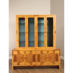 a wooden cabinet with glass doors on top