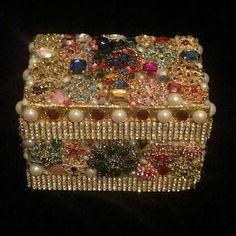 an elaborately decorated box with pearls and other jeweled objects on it's sides