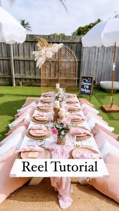 a table set up with pink napkins and place settings for an outdoor dinner party