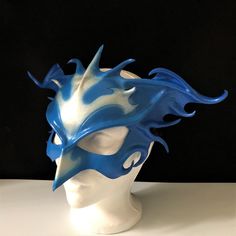 DESCRIPTIONRebirth & renewal - a blue phoenix rising from the ashes: Transform into this legendary mystical bird! This gorgeous blue & silver leather Phoenix Mask is a gorgeous, elegant piece suitable for a formal masquerade or Carnivale party. Use for Bird CosPlay. Available in red & gold. Waterproofed leather, glossy or matte finish, & several choices to affix the mask (cord, elastic, ribbon, waterproof cord). Measurements: 10" high x 14" wide (tallest & widest points); 10" Blue Masks And Prosthetics For Cosplay Events, Phoenix Mask, Formal Masquerade, Bird Cosplay, Animal Masquerade Mask, Carnivale Costume, Phoenix Rising From The Ashes, Phoenix Costume, Rising From The Ashes