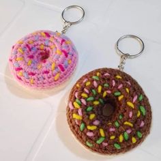 two crocheted doughnut keychains with sprinkles on them