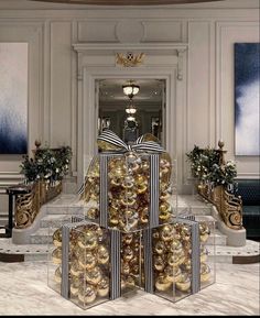 a large group of christmas presents sitting on top of each other in front of a staircase