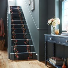 a stair case with flowers painted on it