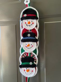 crocheted snowmen hanging on the front door