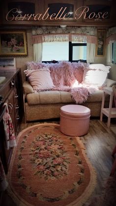 a living room with a couch and rug in front of a window on the wall