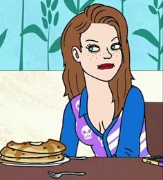 a woman sitting at a table in front of a stack of pancakes