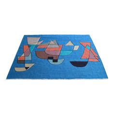 a blue rug with colorful shapes on it