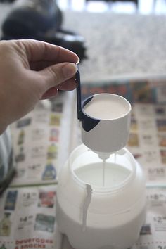 a person is pouring milk into a blender