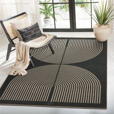 a black and white area rug with two circles on the floor next to a chair