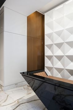 a black and white reception table in front of a wall with geometric designs on it