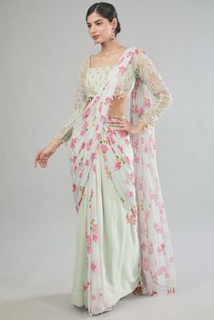 Featuring a green pre-draped saree in chiffon base with floral print. It is paired with a hand embroidered organza blouse having pearl detail. Style it with statement jewellery and heels for weddings. Elegant Floral Print Pre-draped Saree For Designer Wear, Elegant Floral Print Lehenga With Traditional Drape, Elegant Floral Print Floor-length Saree, Elegant Floor-length Floral Print Saree, Floral Print Georgette Pre-draped Saree, Floral Print Pre-draped Georgette Saree, Elegant Lehenga Saree With Floral Print, Festive Floral Pre-draped Saree For Party, Festive Pre-draped Saree With Floral Print And Traditional Drape