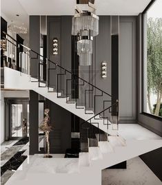 an elegant staircase with chandelier and marble floors