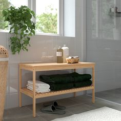 a bathroom with a plant and towels on the counter