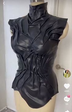 a mannequin wearing a black leather top