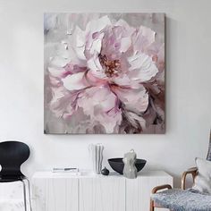 a white and pink flower on a canvas in a living room