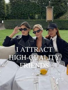 three women sitting at a table with wine glasses in front of them and the words, i attract high - quality friends