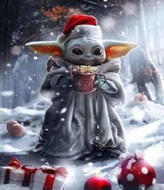 a baby yoda holding a cup in the snow with christmas decorations around it and presents