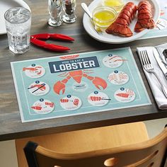 lobsters are displayed on a table with plates and silverware