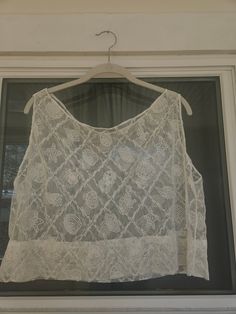 Seashell lace tank top. Would make a super cute beach cover-up! Dimensions:  Width: 23" Length: 18" To ensure a good fit, I recommend comparing these measurements to a tank top that fits you well. Lace Patchwork Camisole Tank Top, Sleeveless Lace Crop Top With Lace Trim, White Lace Patchwork Camisole Tank Top, Sleeveless Lace Camisole With Lace Patchwork, Spring Lace Patchwork Sleeveless Crop Top, Spring Sleeveless Lace Patchwork Crop Top, Sleeveless Lace Patchwork Crop Top, Sleeveless Lace Patchwork Crop Top For Spring, Summer Delicate Lace Cami Tank Top