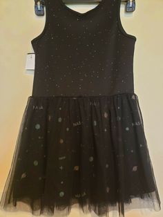 Buzz Aldrin Girl's Black dress with glitter and tulle, Size L. Dress is Black sleeveless scoop neck w/ Green, Pink, & Silver stars, planets & NASA under a black tulle skirt. Very cute. Glitter is also all over the top half. See Photos for Accuracy. We are a USA seller located in Lafayette, Louisiana. PLEASE NOTE: See pictures for accurate condition.  The item listed is the EXACT item you will be receiving. If you have any additional concerns or questions about any image or need more info please Black Dress With Glitter, Black Tulle Skirt, Lafayette Louisiana, Tulle Skirt Black, Girls Black Dress, Buzz Aldrin, Black Tulle, Black Sleeveless, Silver Stars