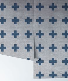 two pieces of fabric with blue crosses on them, one in grey and the other in dark blue