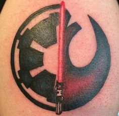 a star wars tattoo on the back of a man's arm with a darth vader symbol