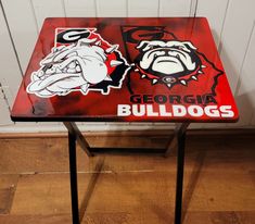 a red table with two bulldogs stickers on it