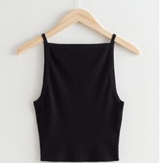 Black Ribbed Knit Tank Black Seamless Tops For Fall, Black Seamless Top For Fall, Trendy Black Ribbed Tank Top, Black Seamless Knit Tops, Black Sleeveless Tank Top With Ribbing, Cheap Ribbed Black Tank Top, Black Ribbed Fitted Tank Top, Black Ribbed Cotton Tank Top, Black Top Summer