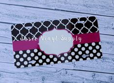 a black and white polka dot bag with a pink ribbon on it that says dixie vinyl supply