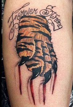 a tattoo on the leg of a person with blood dripping from it