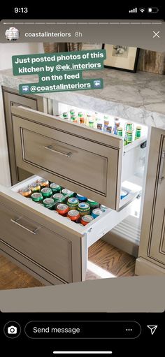 an open drawer in the middle of a kitchen