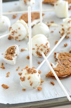 marshmallows and cookies are sitting on top of each other with toothpicks sticking out of them