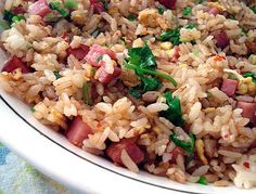 a white bowl filled with rice and meat